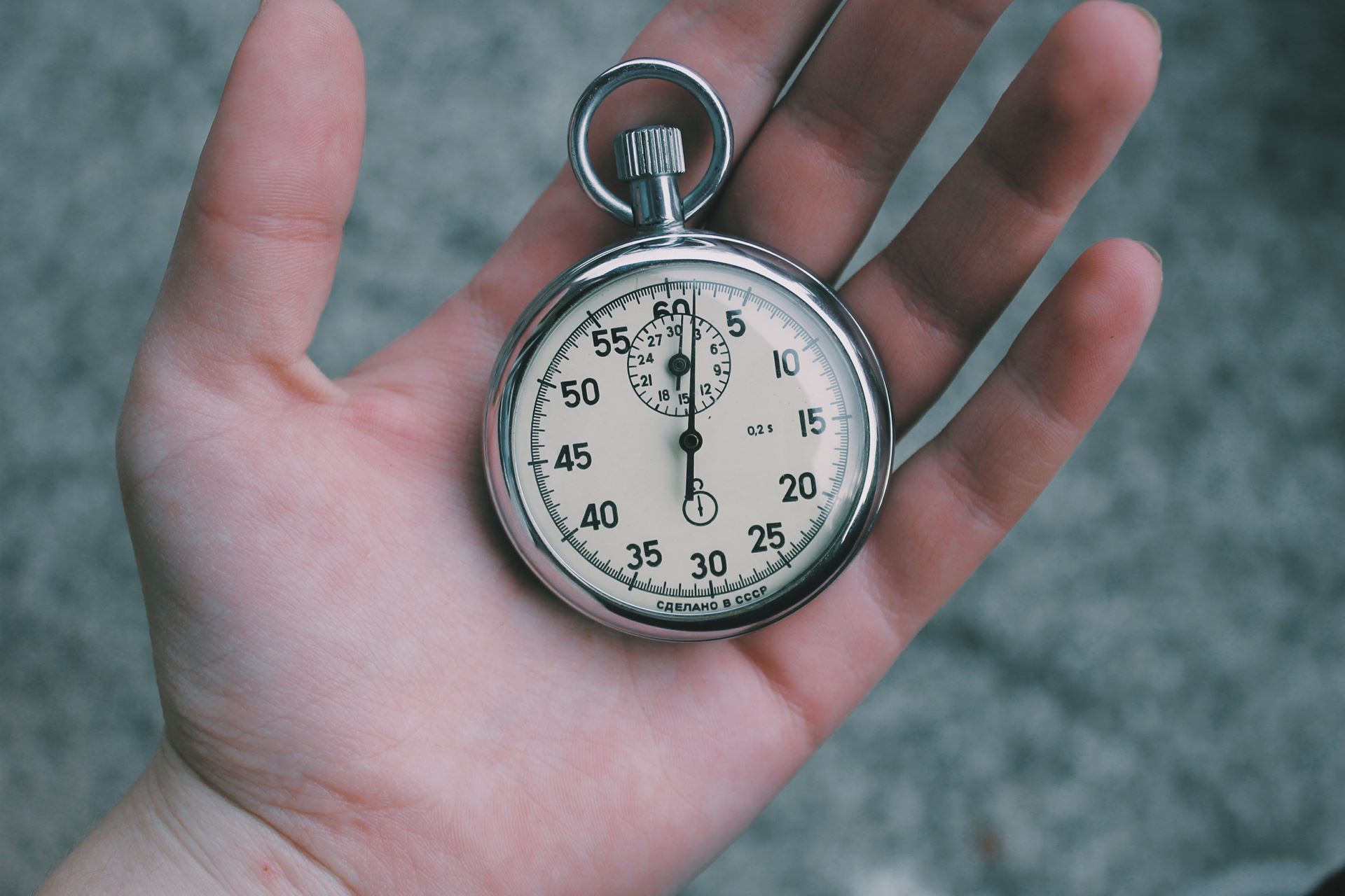 a hand holding a watch